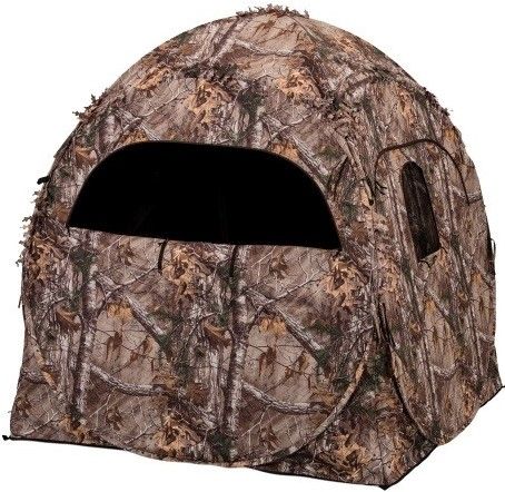 Ameristep 1RX2S010 Doghouse Blind-Realtree Xtra, Heavy duty non reflective fabric, Spring steel for easy setup and long-lasting durability, Ideal for firearm or archery hunting, Portable and compact concealment, Shoot through mesh windows with gun port, Durashell water resistant outer fabric, Includes carry bag with backpack carry straps, Dimensions 60
